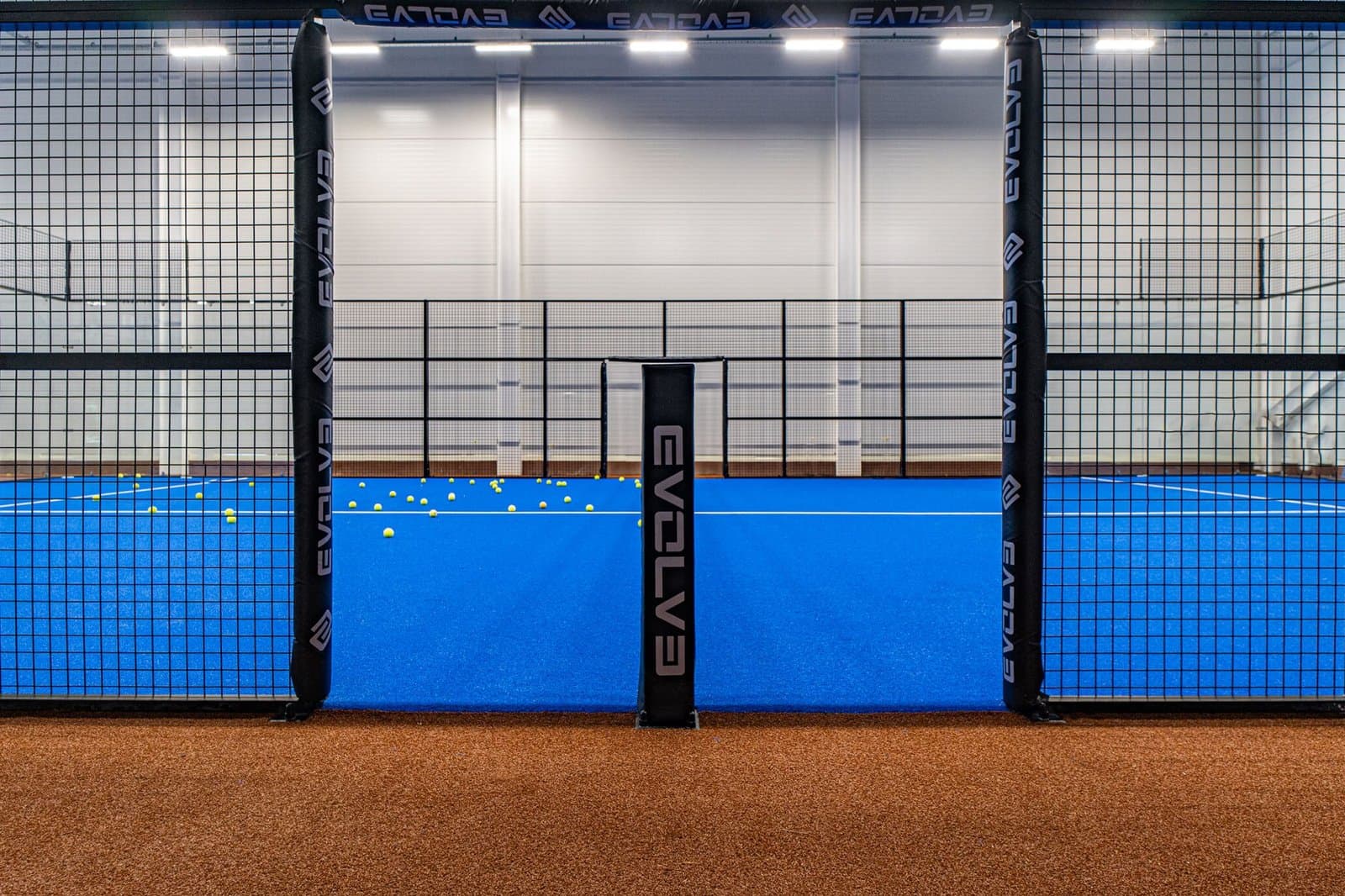 Entrance of an Evolve padel court with branded protective padding