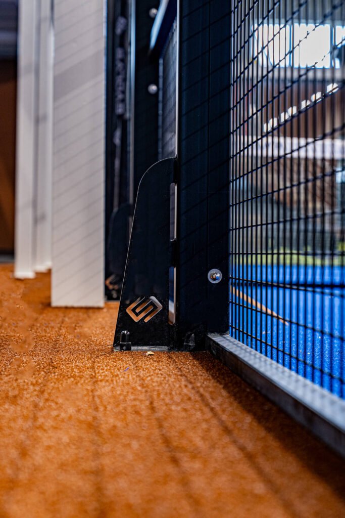 Stainless steel glass fixing detail on an Evolve padel court