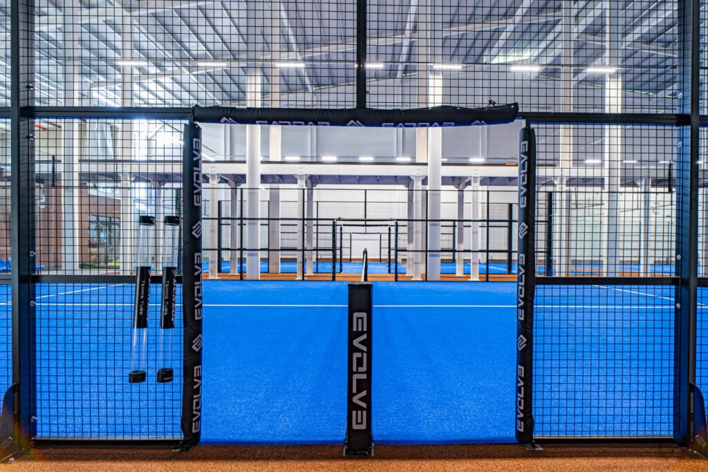 Entrance of an Evolve padel court with branded protective padding